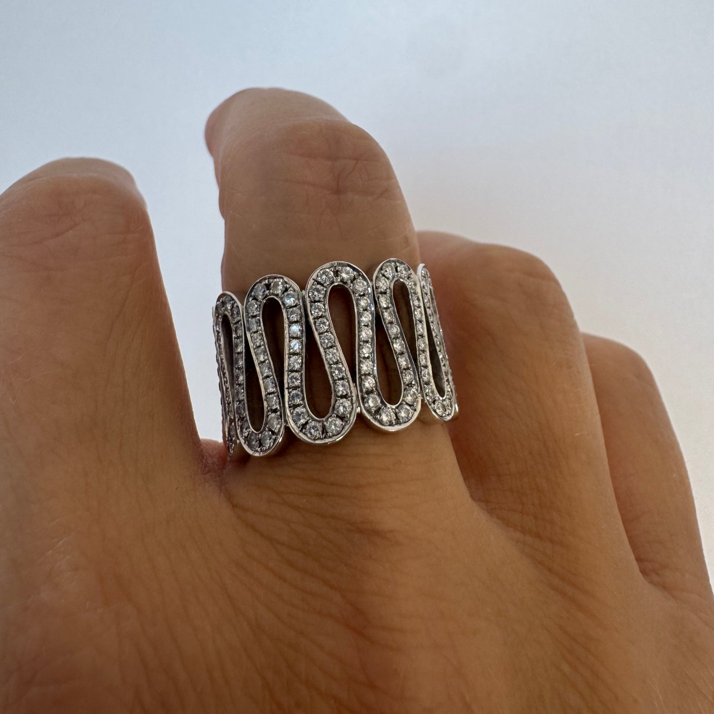 14K gold ring set with shimmering Diamonds in a flowing wave design