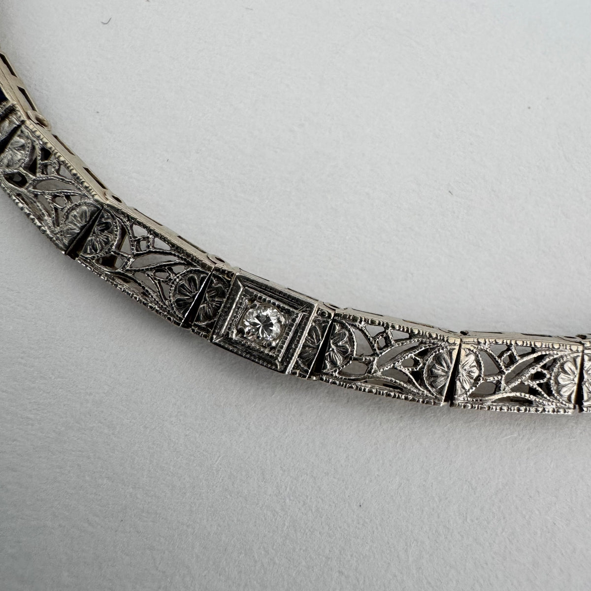 14K gold bracelet featuring intricate openwork and beautifully engraved details set with Sapphire & Diamonds
