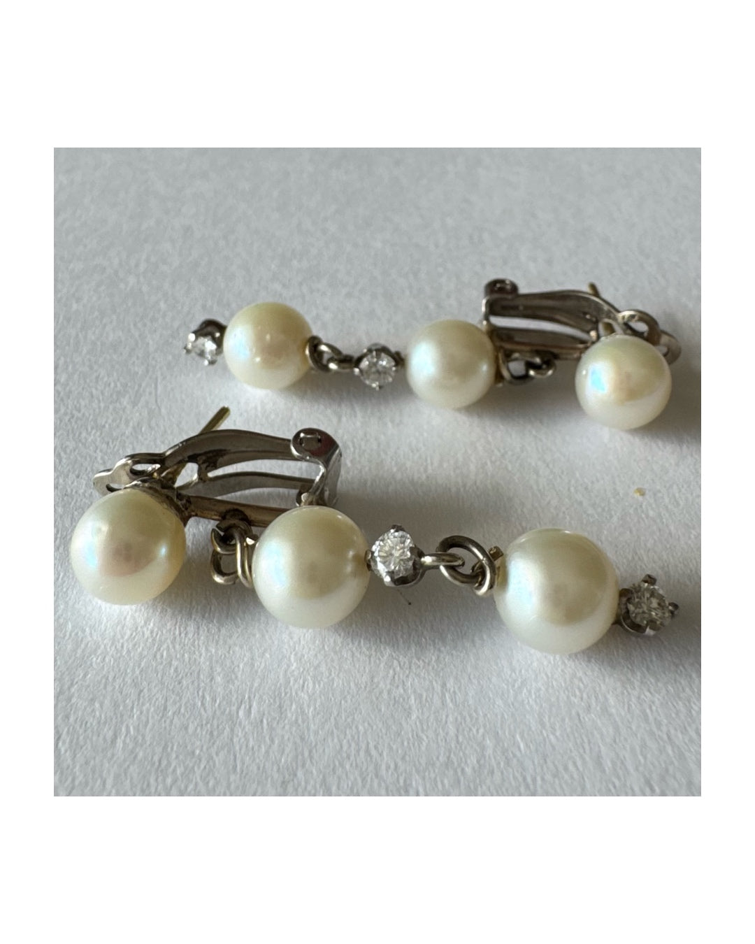 14K gold elegant drop earring set with three soft creamy Pearls connected by round brilliant Diamonds