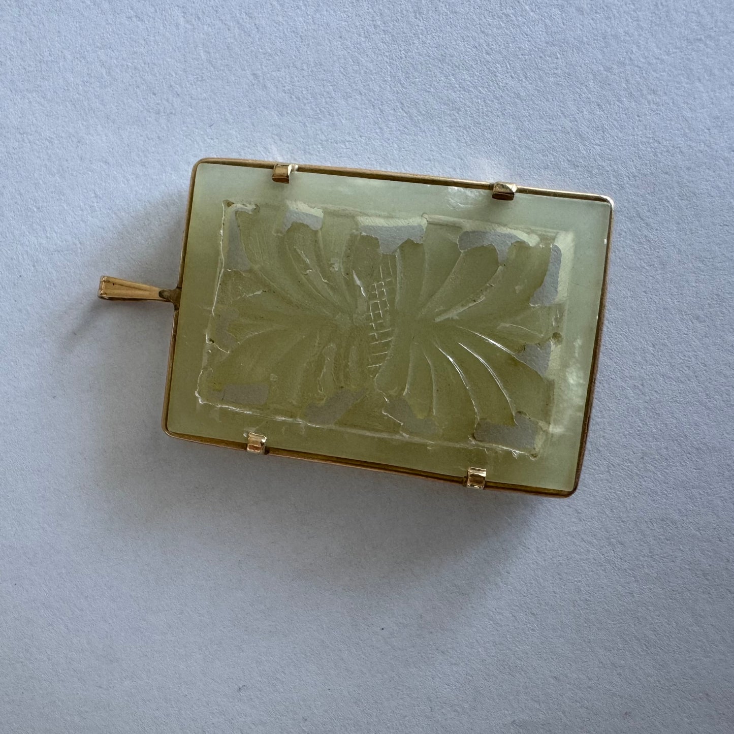 14K gold rectangular pendant set with a hand-carved milky Jade stone
