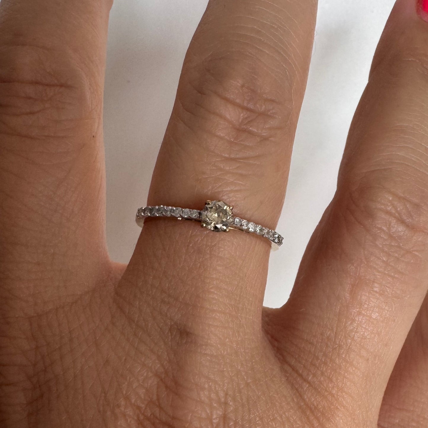 9K gold ring set with a central Diamond and sparkling Diamonds along the band