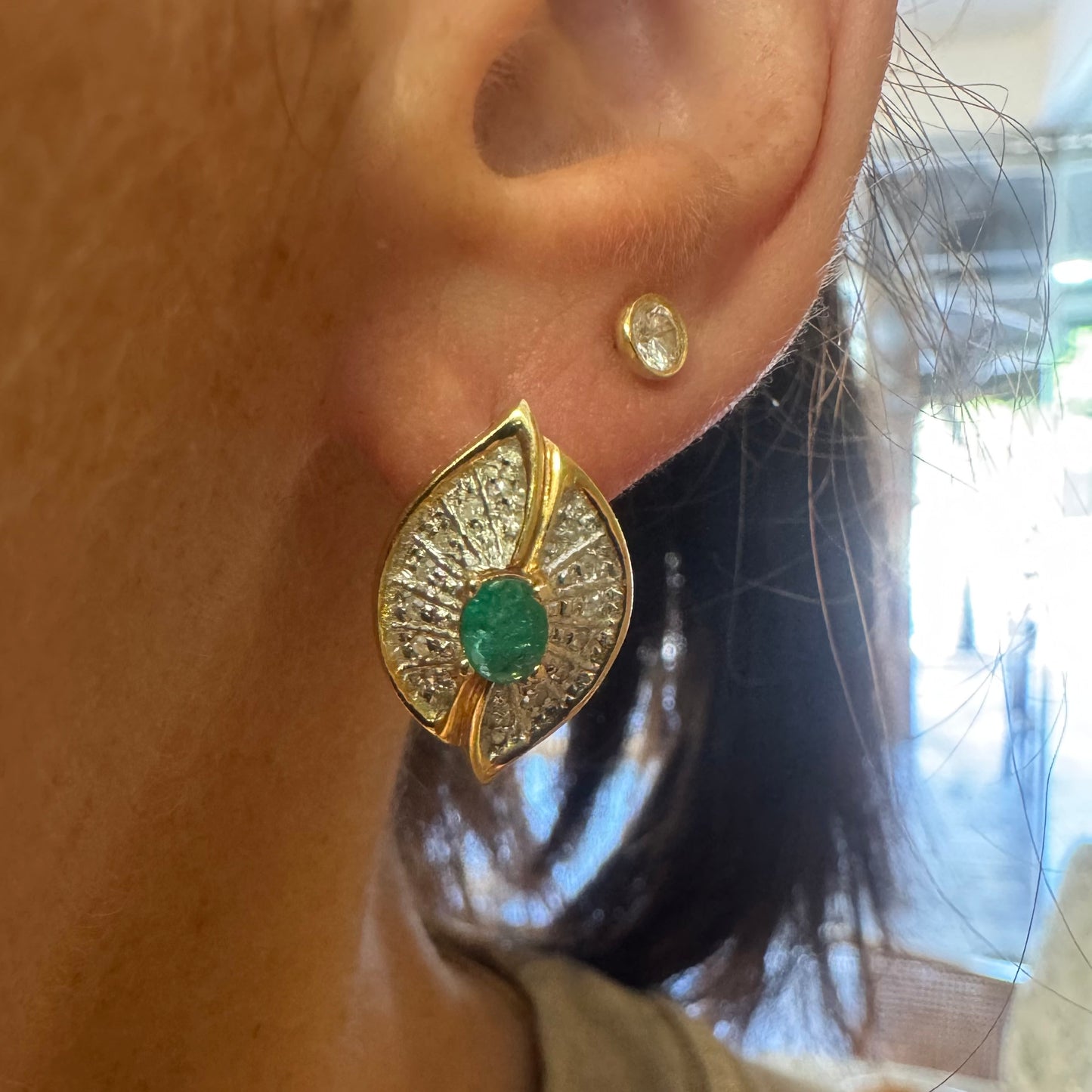 14K gold drop earrings in a refined leaf design, set with vivid green Emeralds at the center and shimmering pavé-set Diamonds along the curves