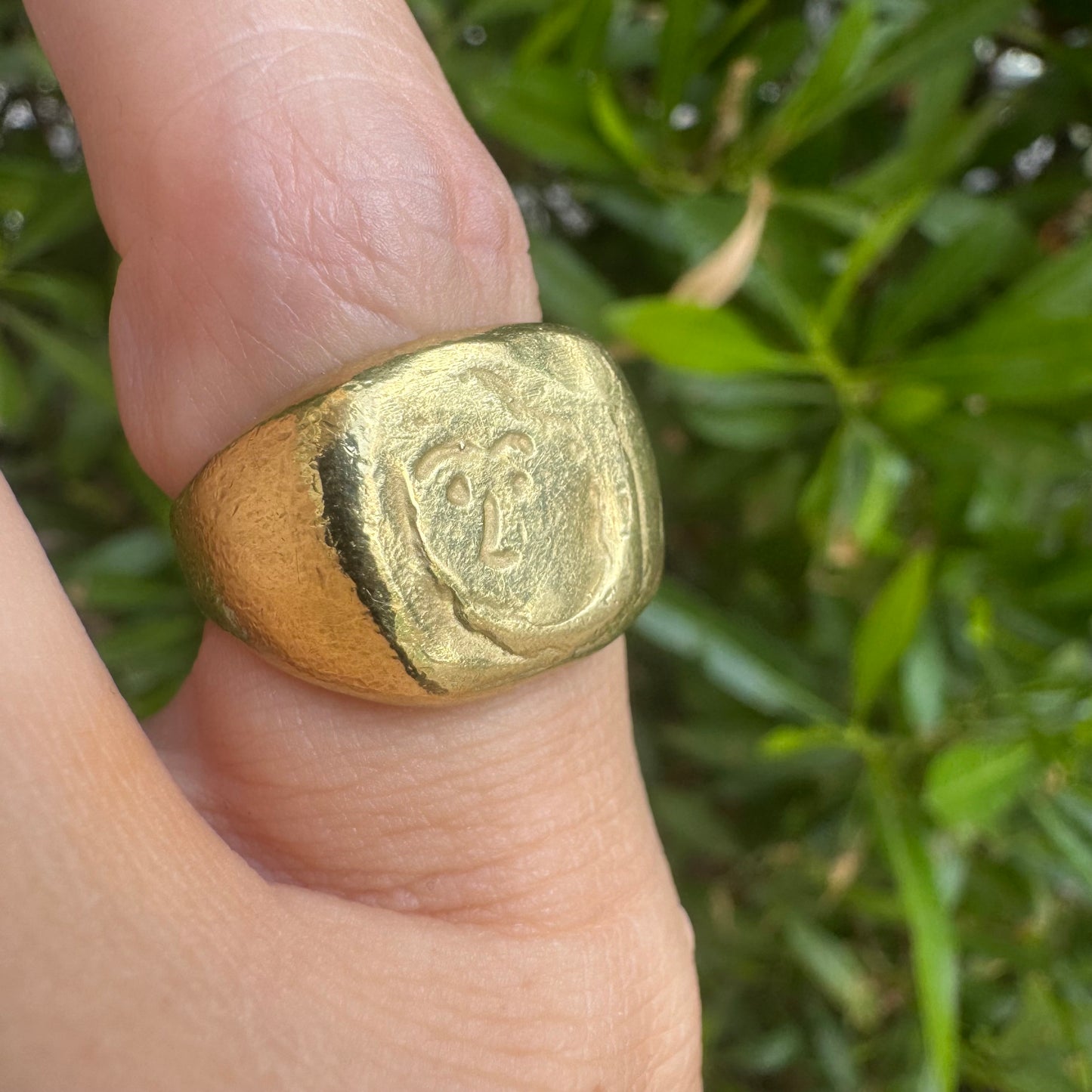 18K gold chunky gold ring with a rustic, organic finish, featuring an engraved abstract face motif at its center.