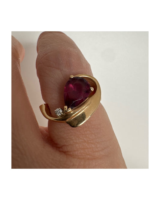 14K gold sculptural open ring set with a pear-cut pink Tourmaline, accented by a small Diamond.