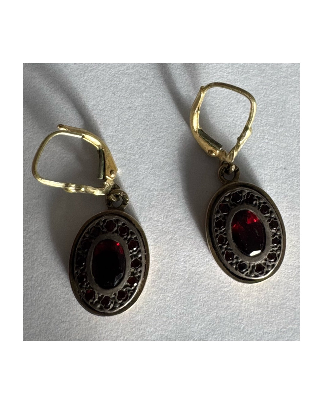 14K gold drop earrings set with deep red oval Garnets surrounded by smaller stones Garnets.