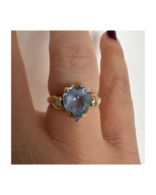 14K gold ring set with a heart-cut Blue Topaz stone