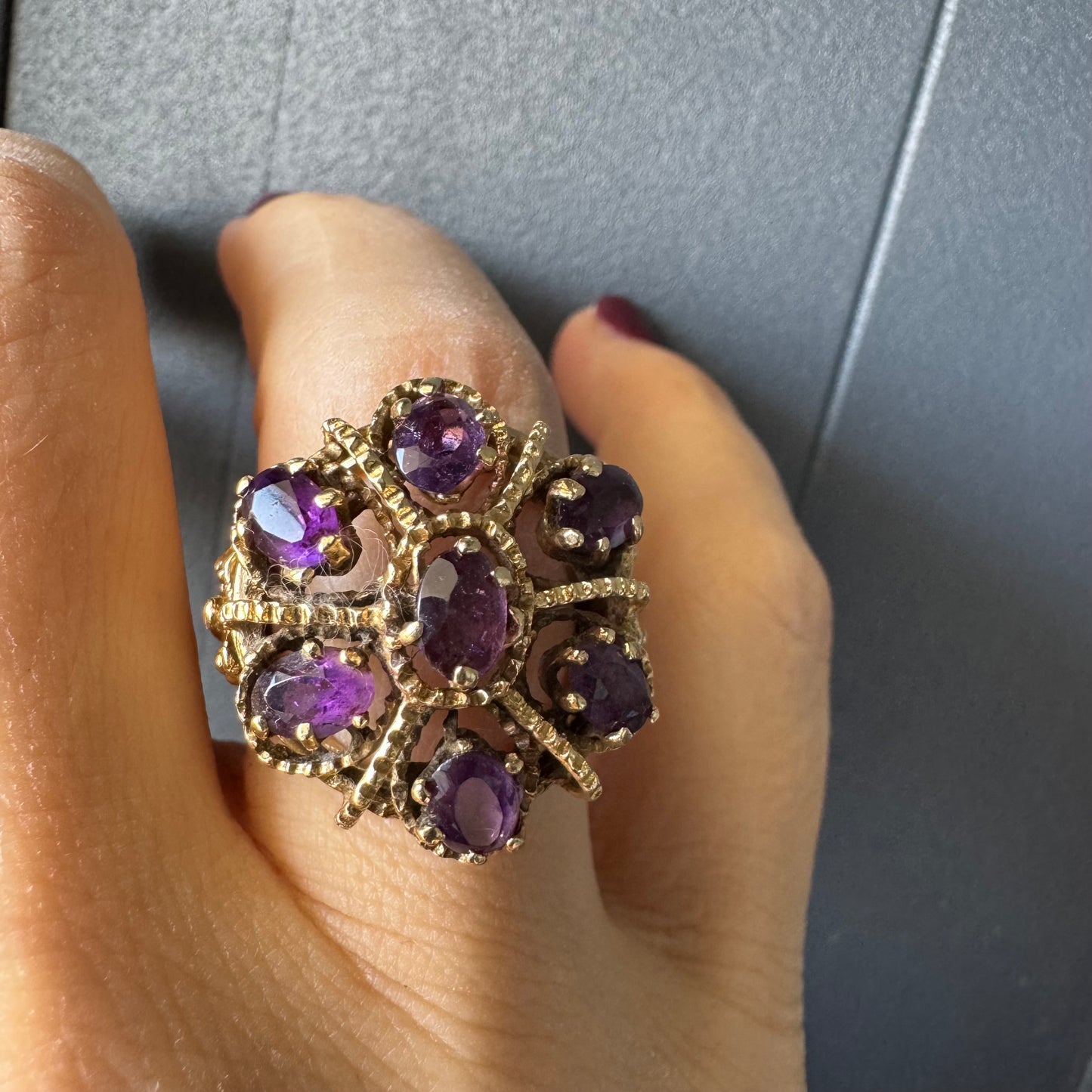 14K yellow gold cocktail ring set with a stunning cluster of Amethyst stones in marquise cuts.