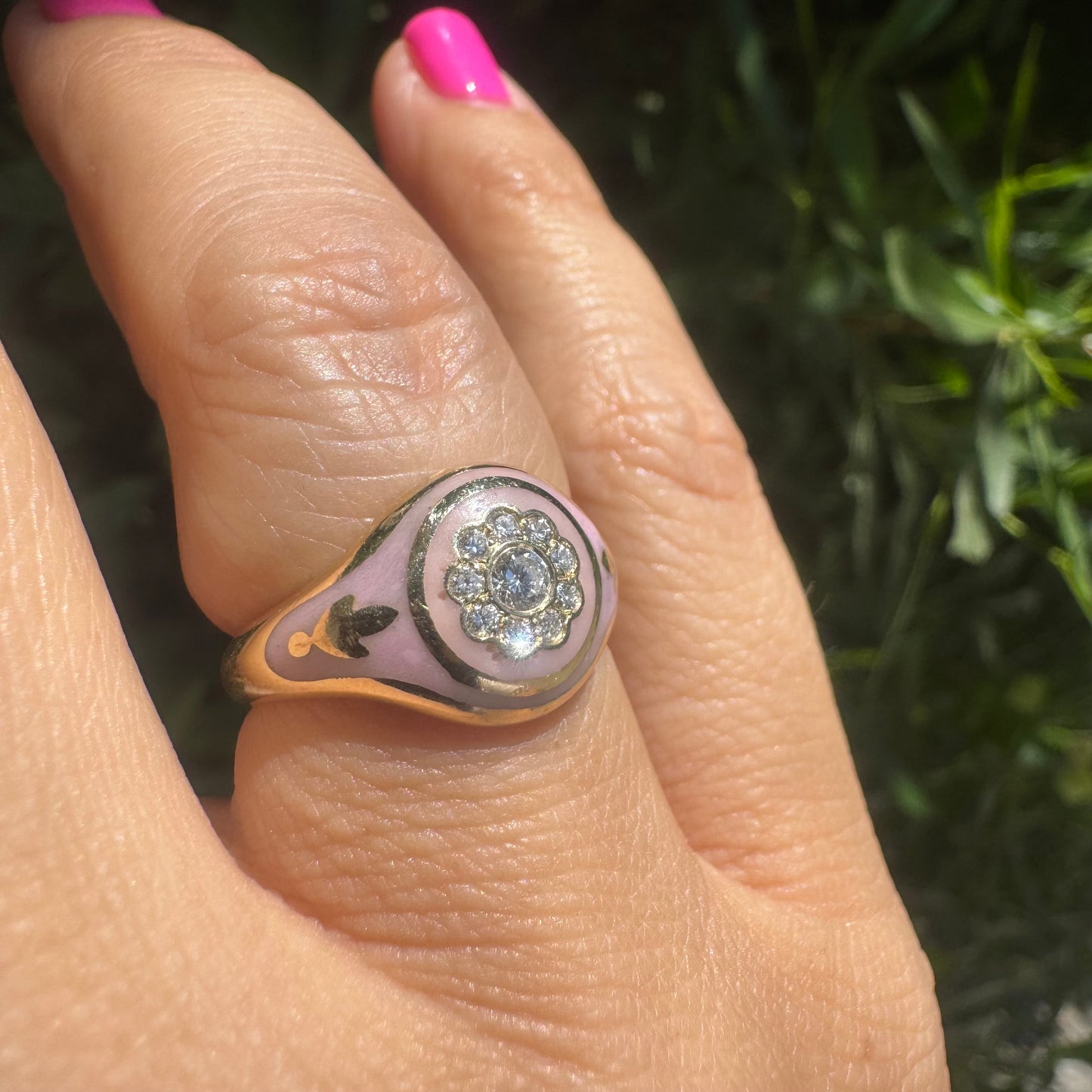 14K gold ring set with soft pink enamel & Diamonds with floral motif at the center.