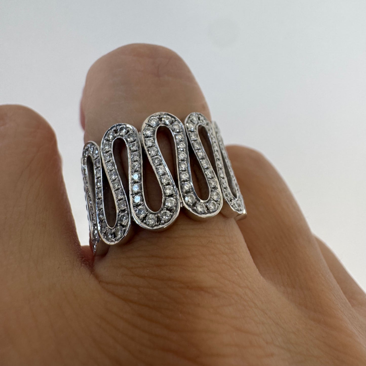14K gold ring set with shimmering Diamonds in a flowing wave design