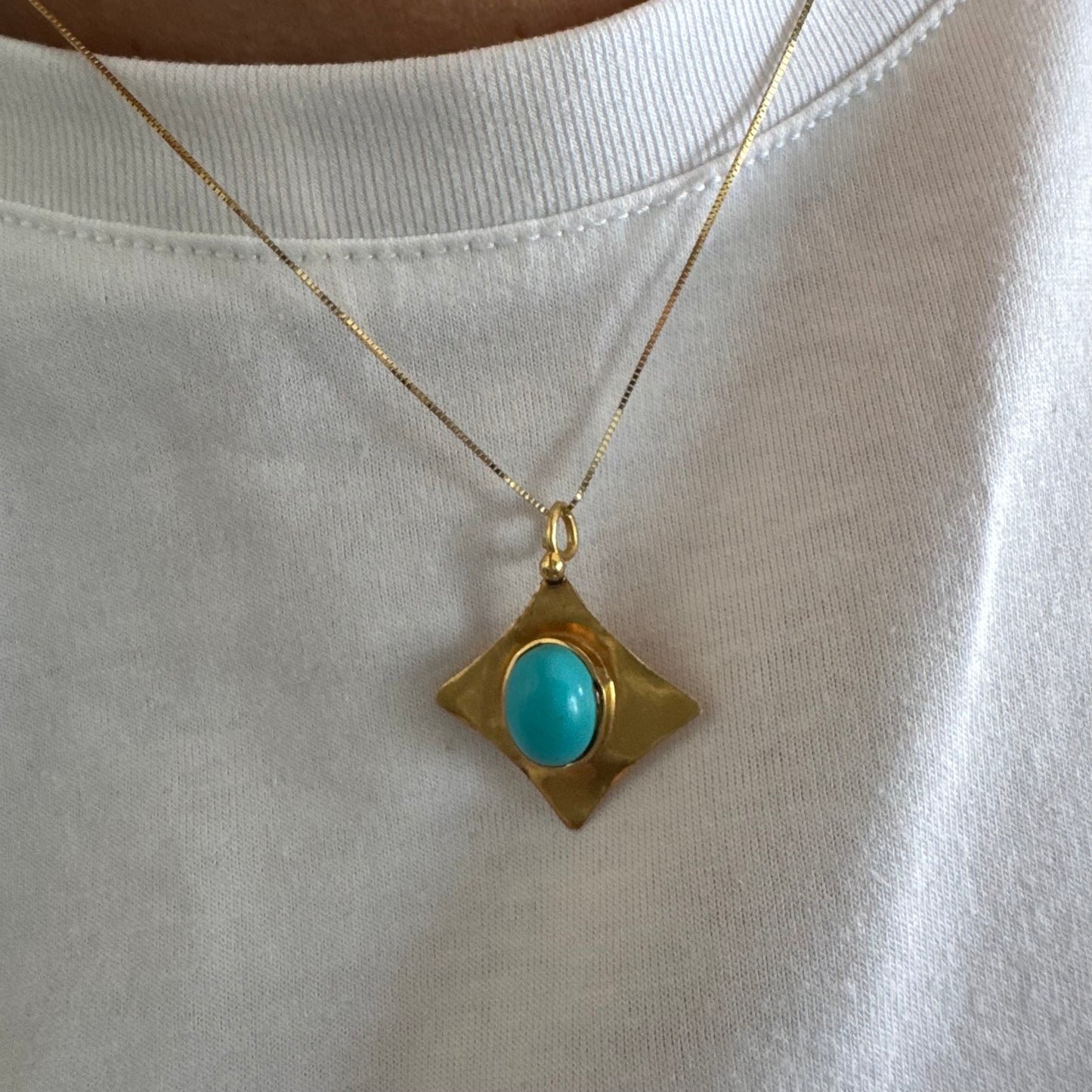 18K gold pendant set with a vibrant Turquoise stone in a bold, geometric design.