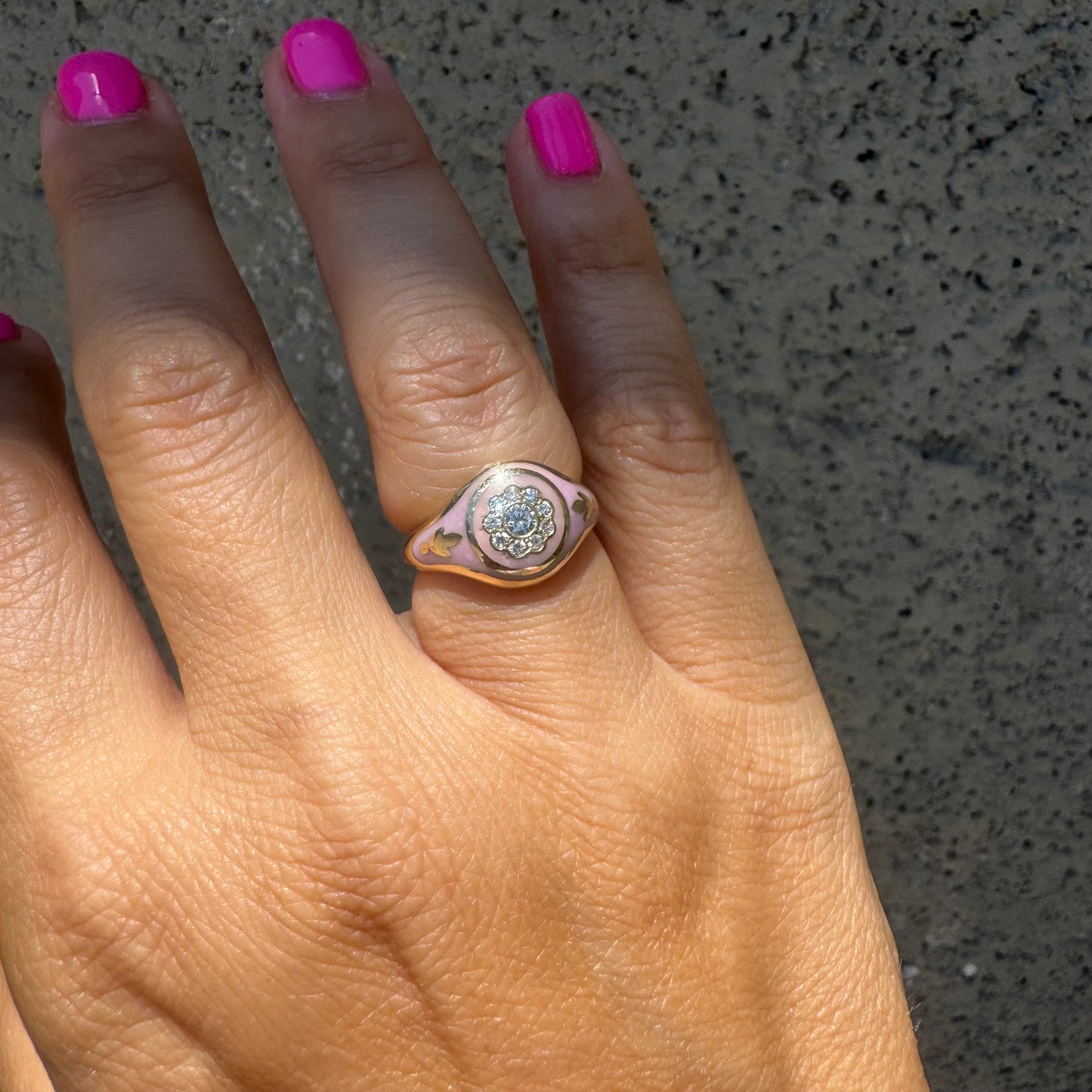 14K gold ring set with soft pink enamel & Diamonds with floral motif at the center.