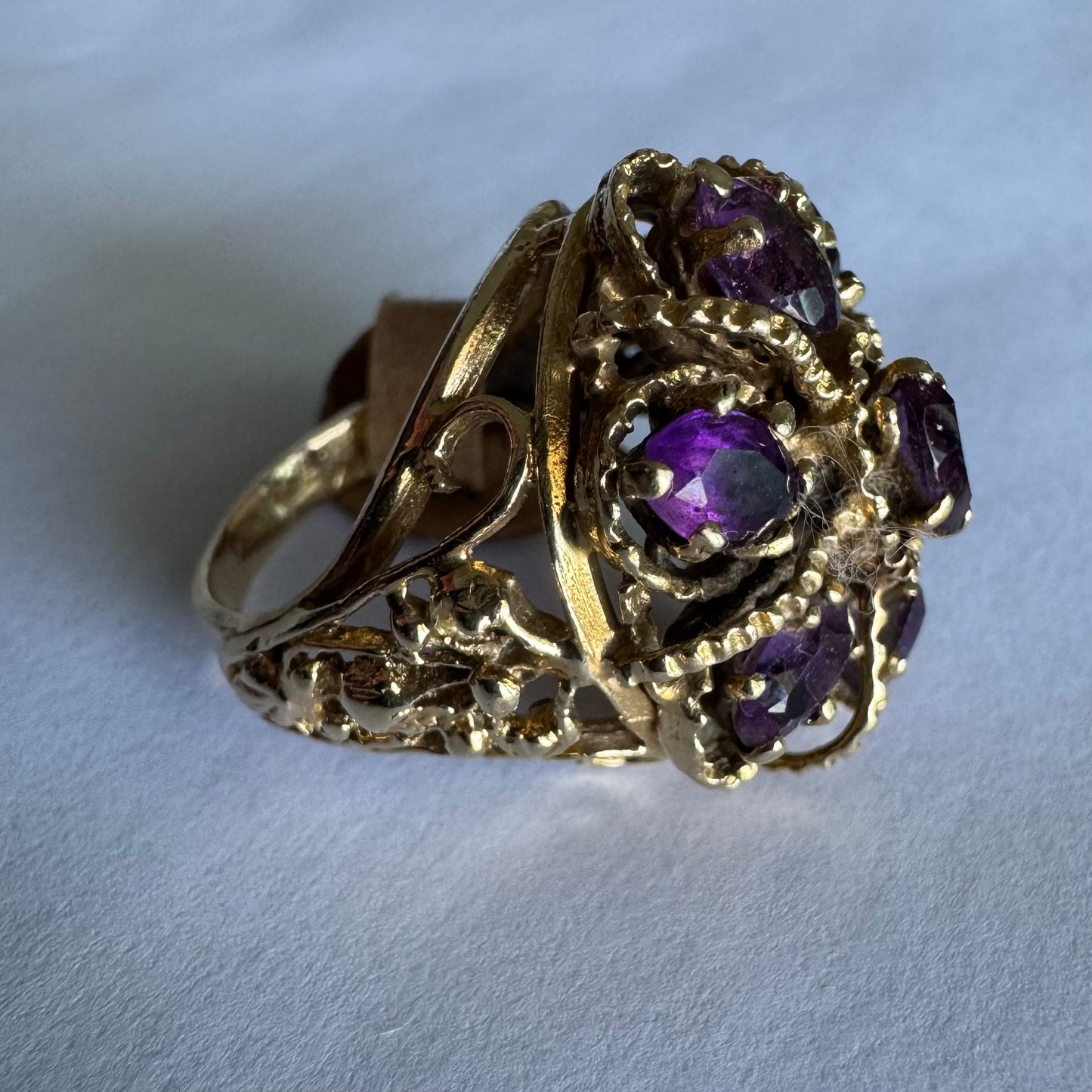 14K yellow gold cocktail ring set with a stunning cluster of Amethyst stones in marquise cuts.