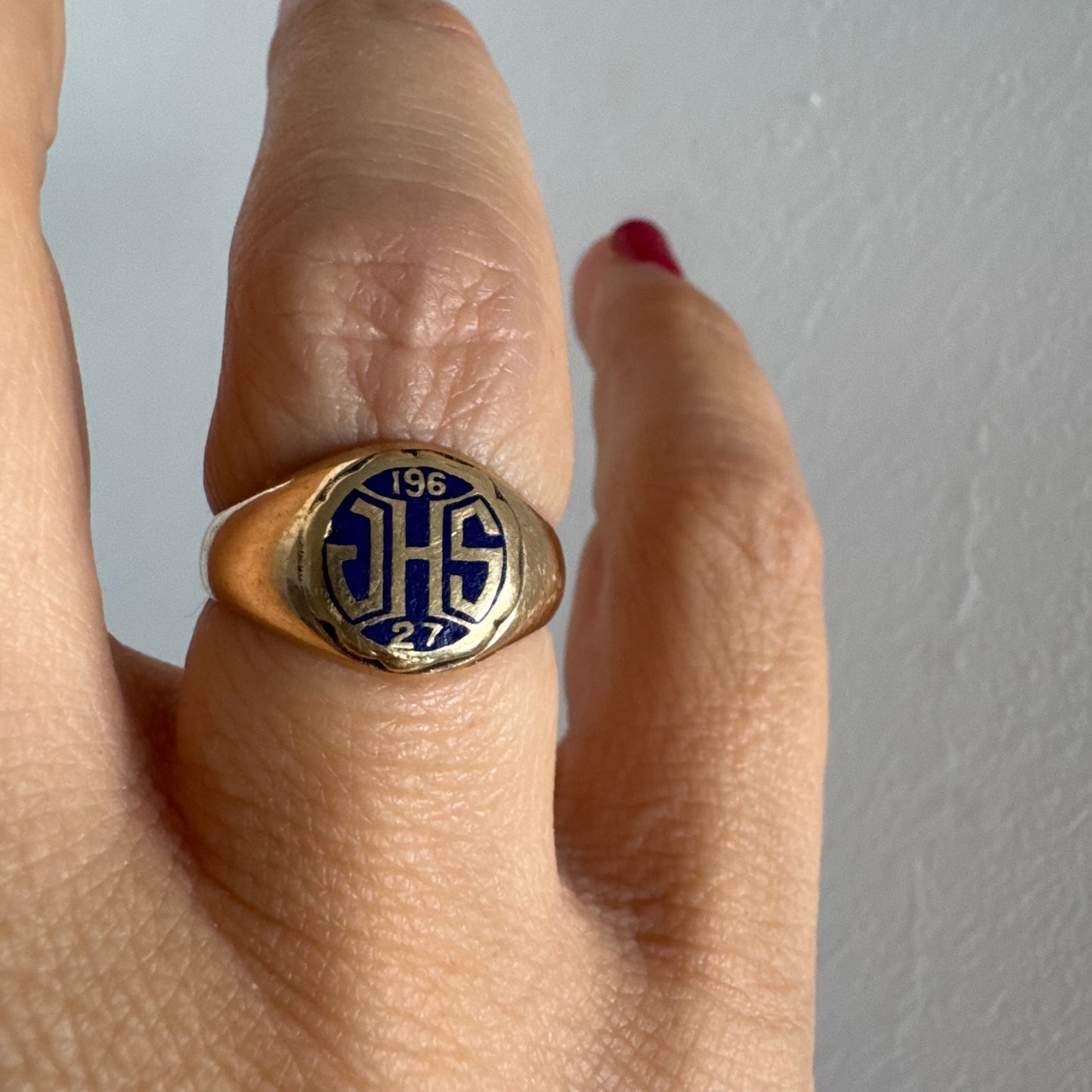 14K gold signet ring featuring an oval face with dark enamel and bold engraved initials at the center.
