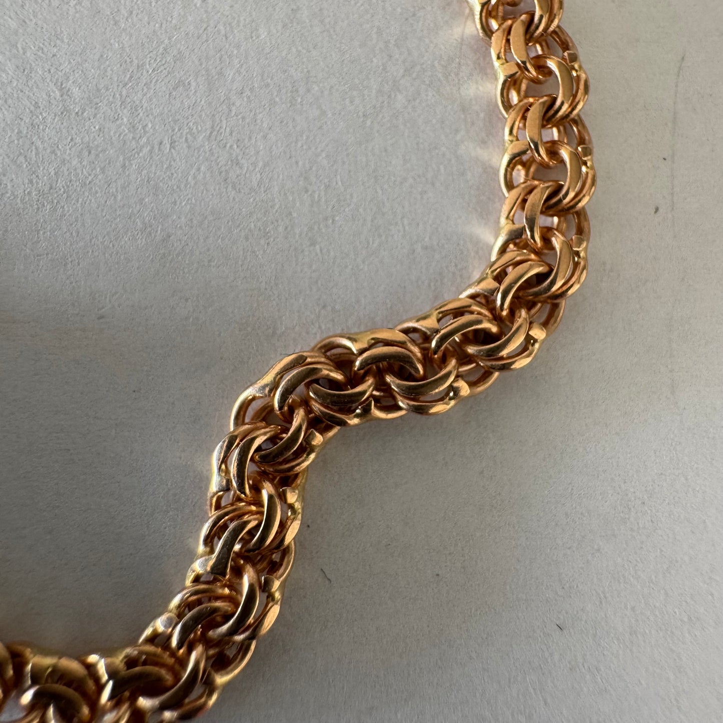 14K gold chain featuring an intricate woven link