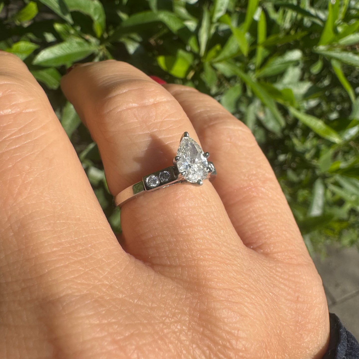 Platinum ring set with one center Pear cut Diamond & side Diamonds