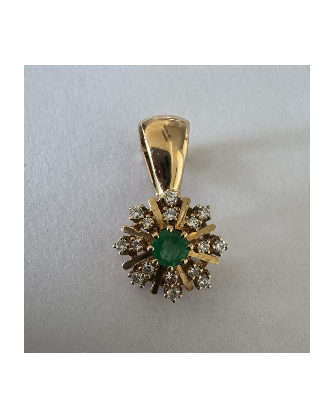 14K gold pendant centered with a Emerald and surrounded by a halo of sparkling Diamonds