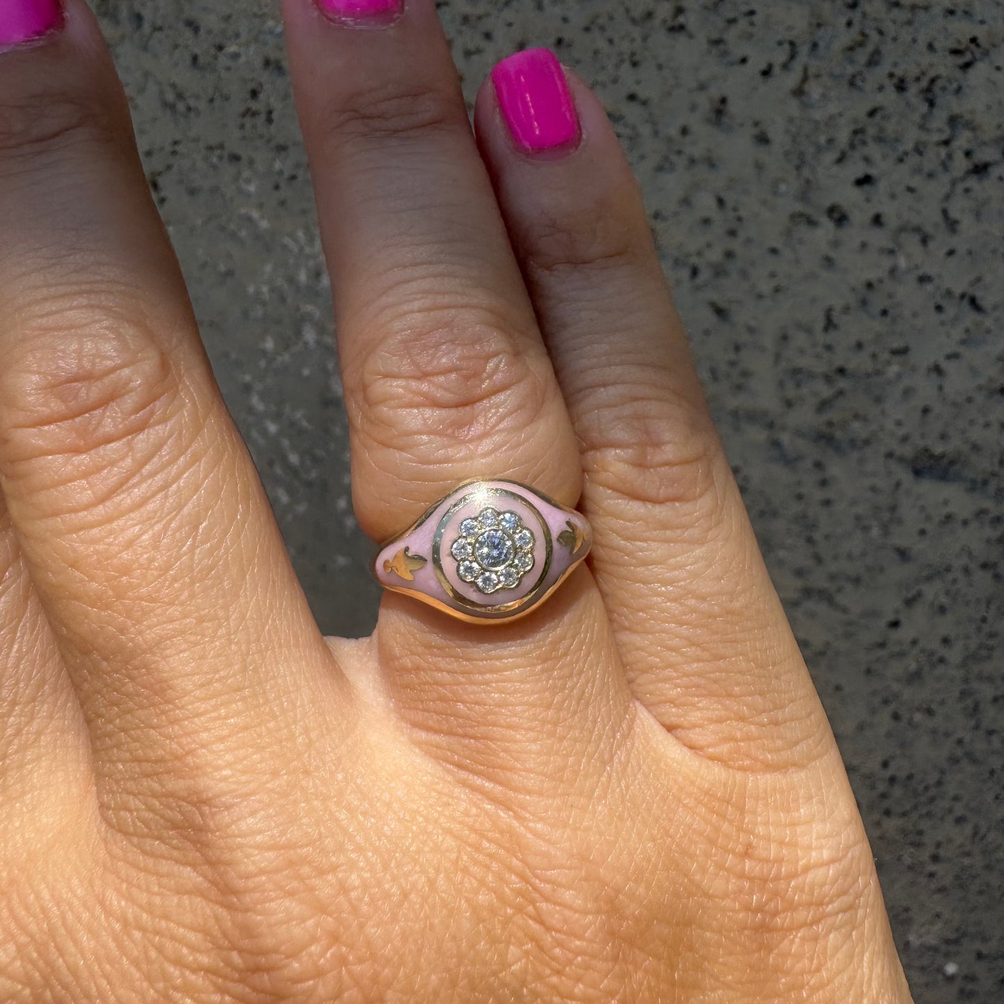 14K gold ring set with soft pink enamel & Diamonds with floral motif at the center.