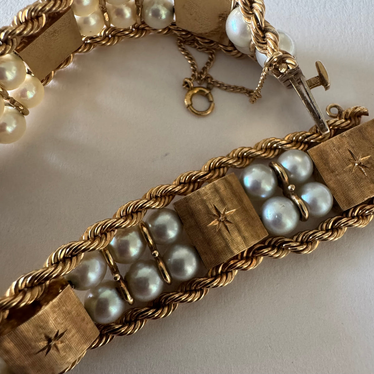 14K gold bracelet set with Pearls, featuring intricate rope-style detailing and textured geometric gold elements.