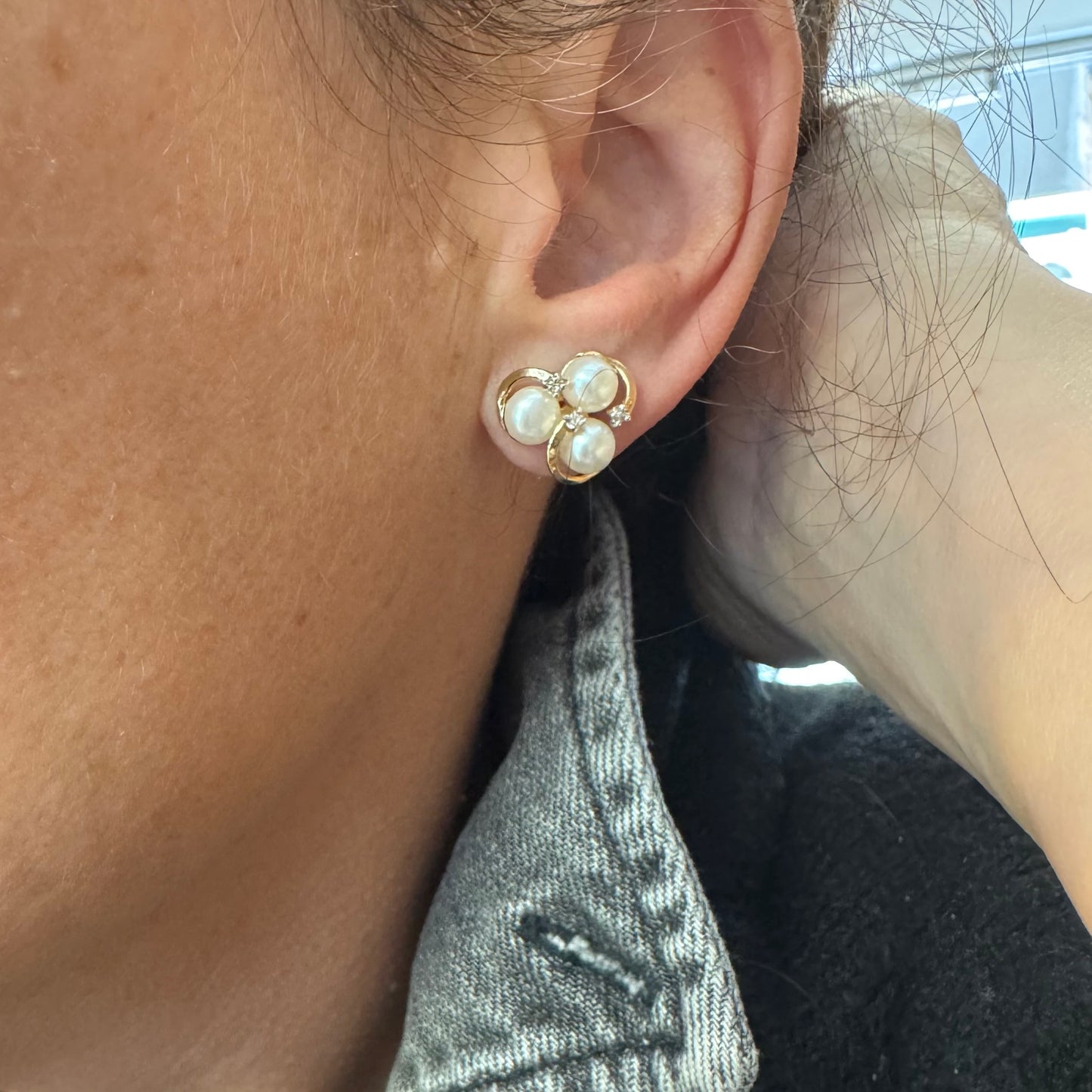 10K gold stud earrings in a delicate floral design, set with three creamy natural Pearls & Diamonds.