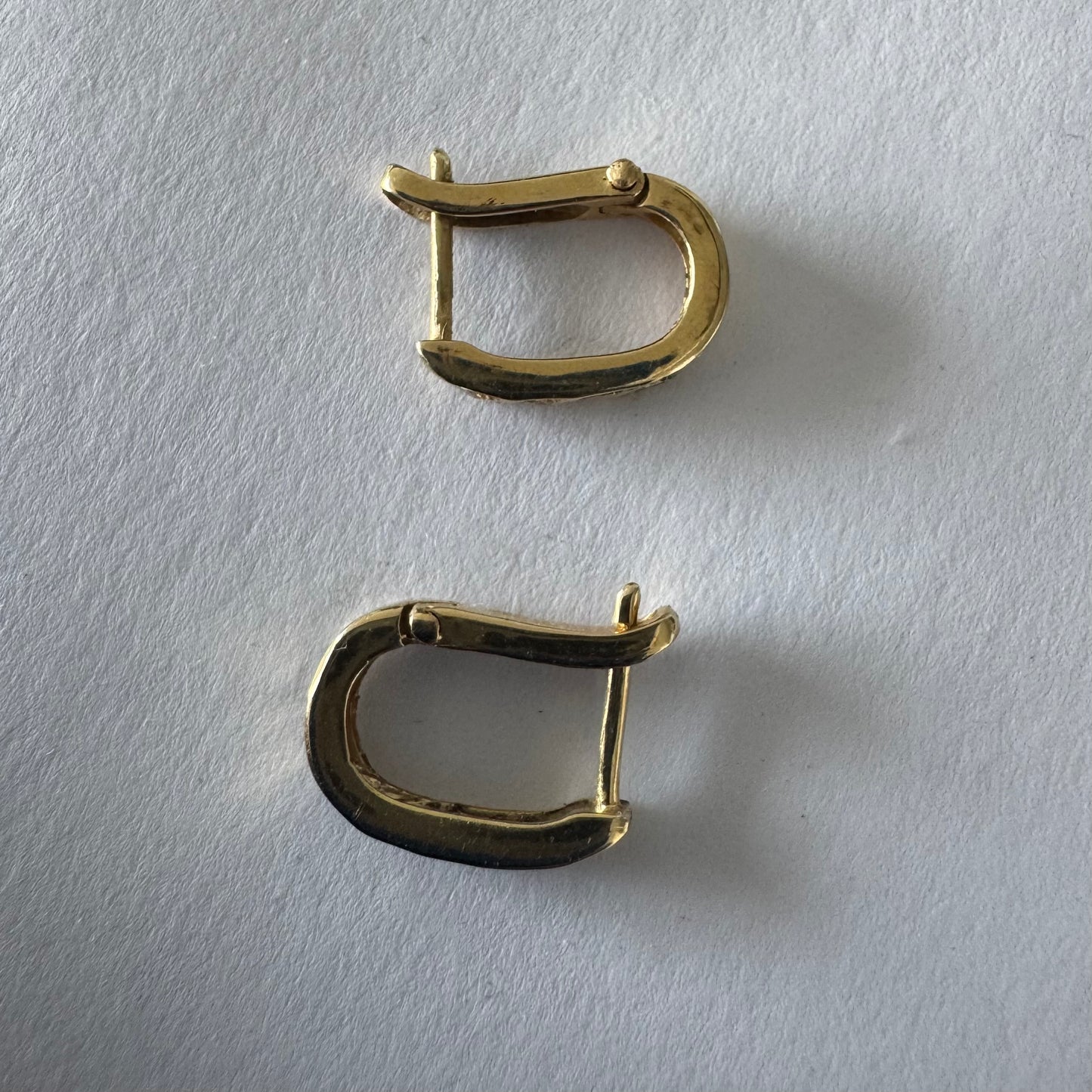 14K gold huggie earrings accented with a delicate row of sparkling Diamonds