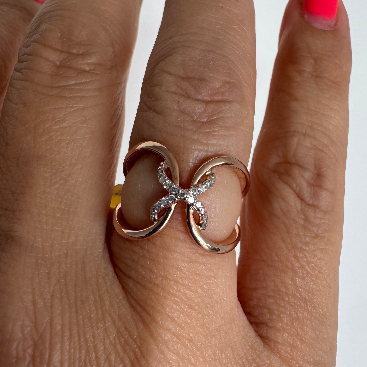 10K rose gold ring set with natural Diamonds in a flowing & artistic design.