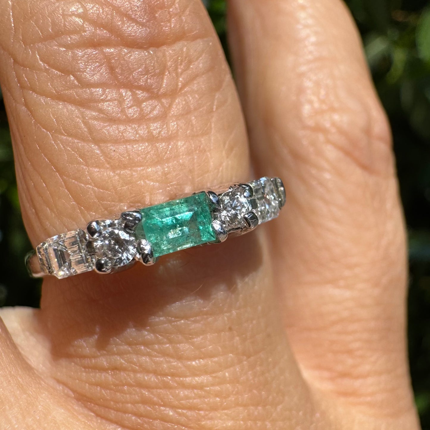 14K gold ring set with one center Emerald & Diamonds on the sides