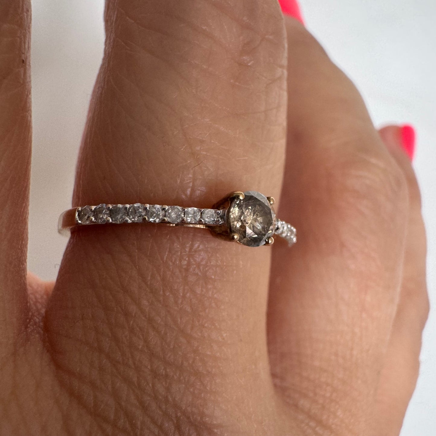 9K gold ring set with a central Diamond and sparkling Diamonds along the band