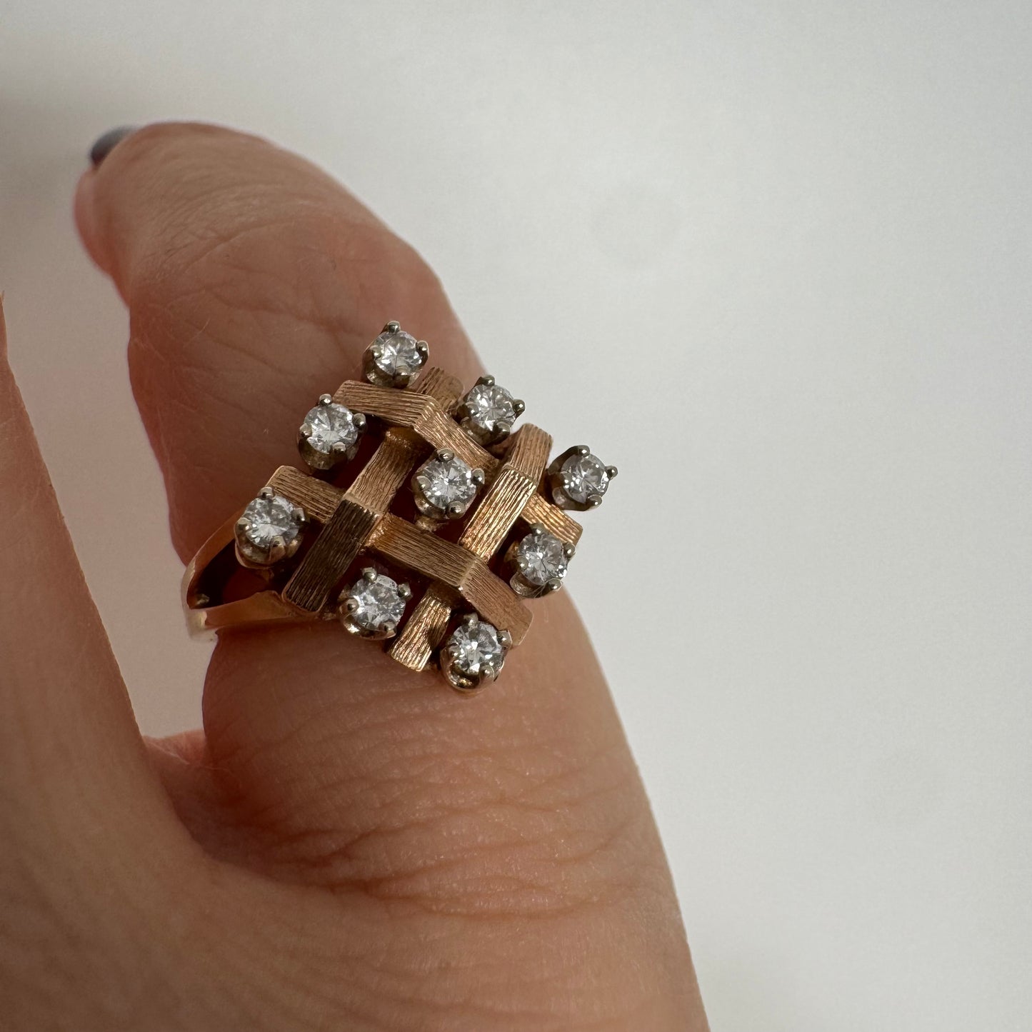 14K gold woven-style ring set with round Diamonds in a symmetrical layout.