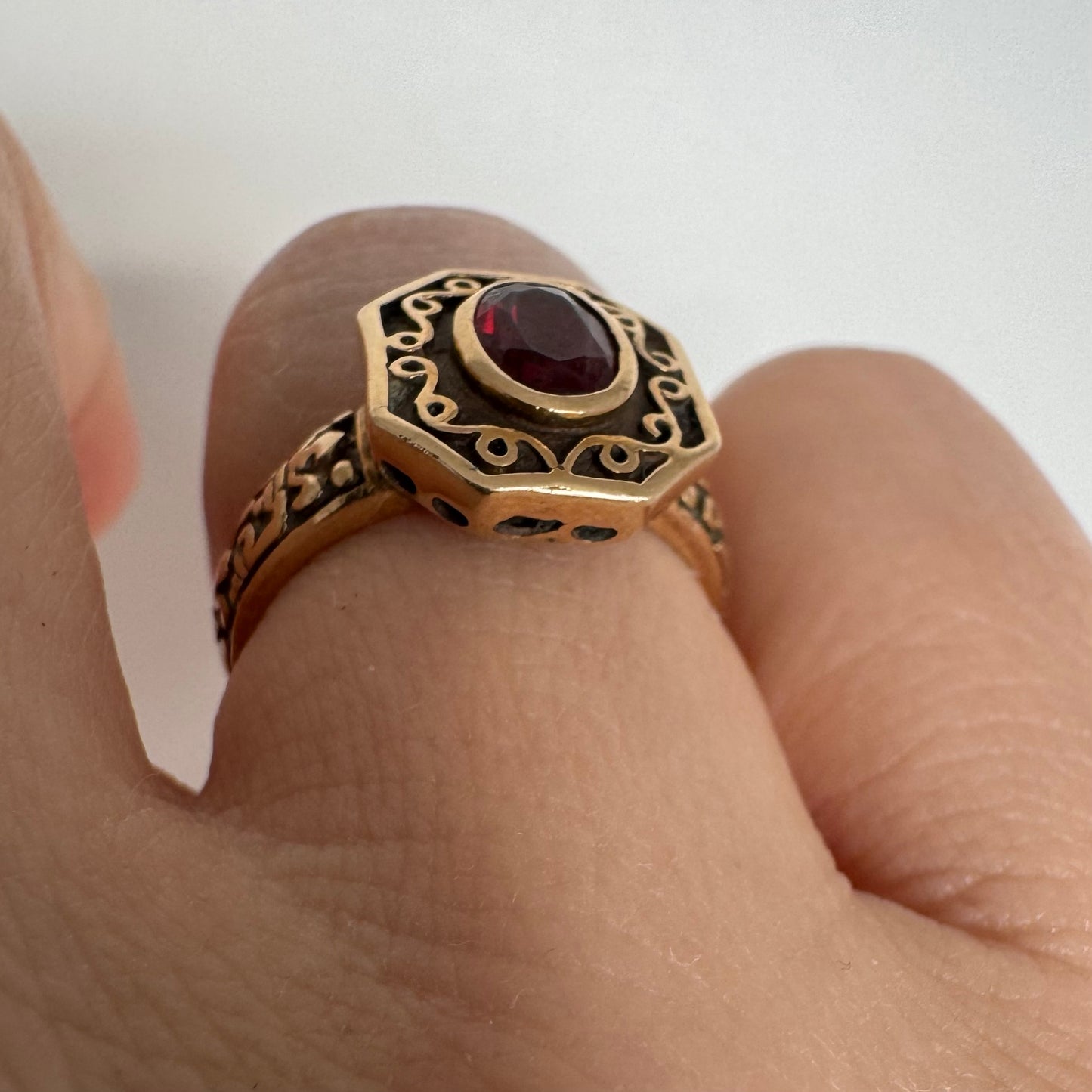 14K gold ring set with an oval deep-red Garnet.