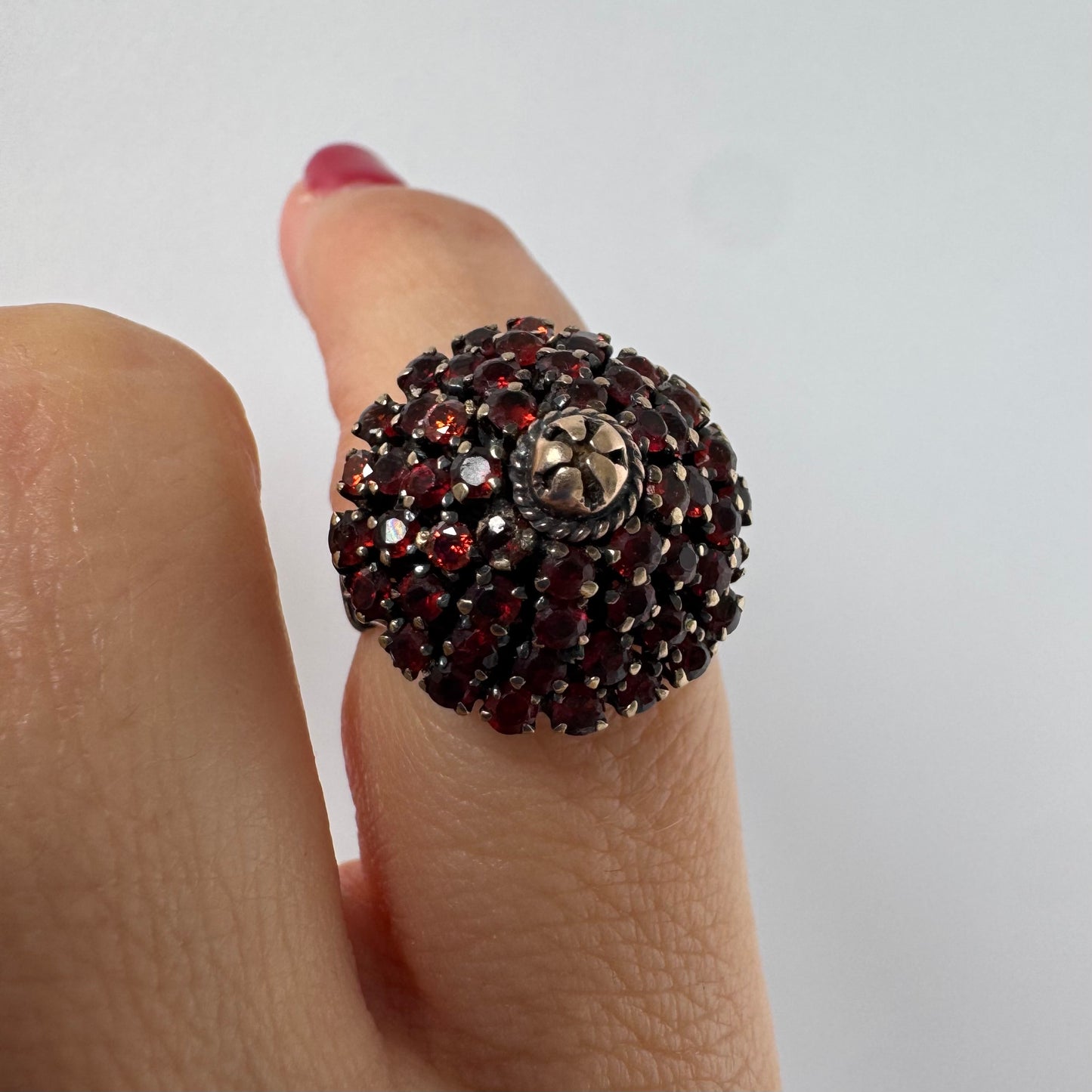 10K gold statement ring designed as a bold floral cluster set with Garnets