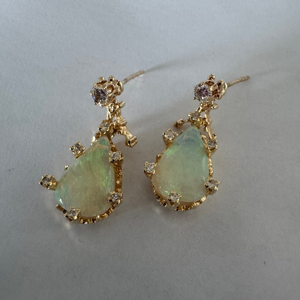 14K gold drop earrings set with pear-shaped Opals and Diamonds.