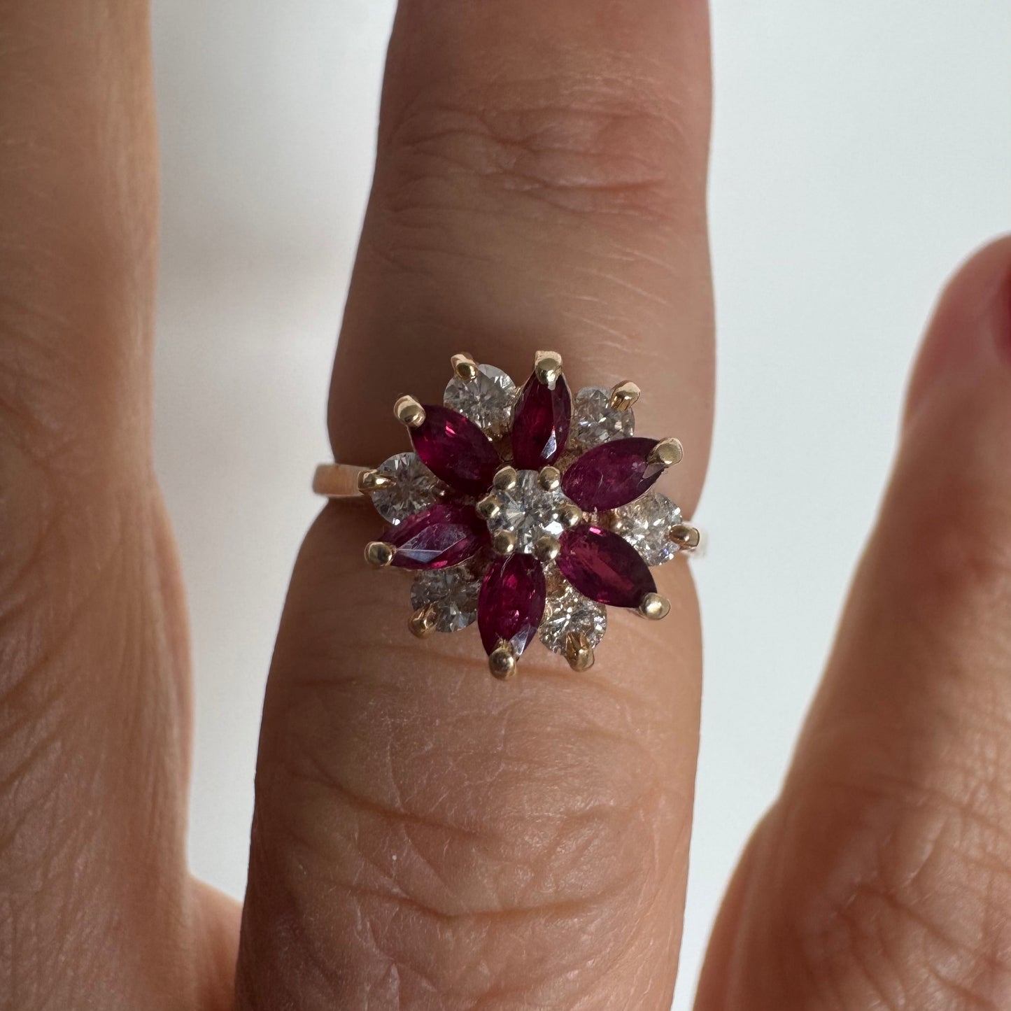 14K gold ring featuring a classic floral-inspired design set with marquise-cut Rubies & Diamonds.