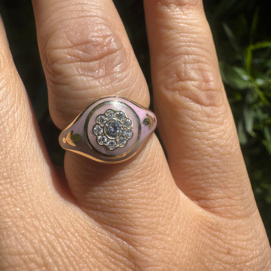 14K gold ring set with soft pink enamel & Diamonds with floral motif at the center.