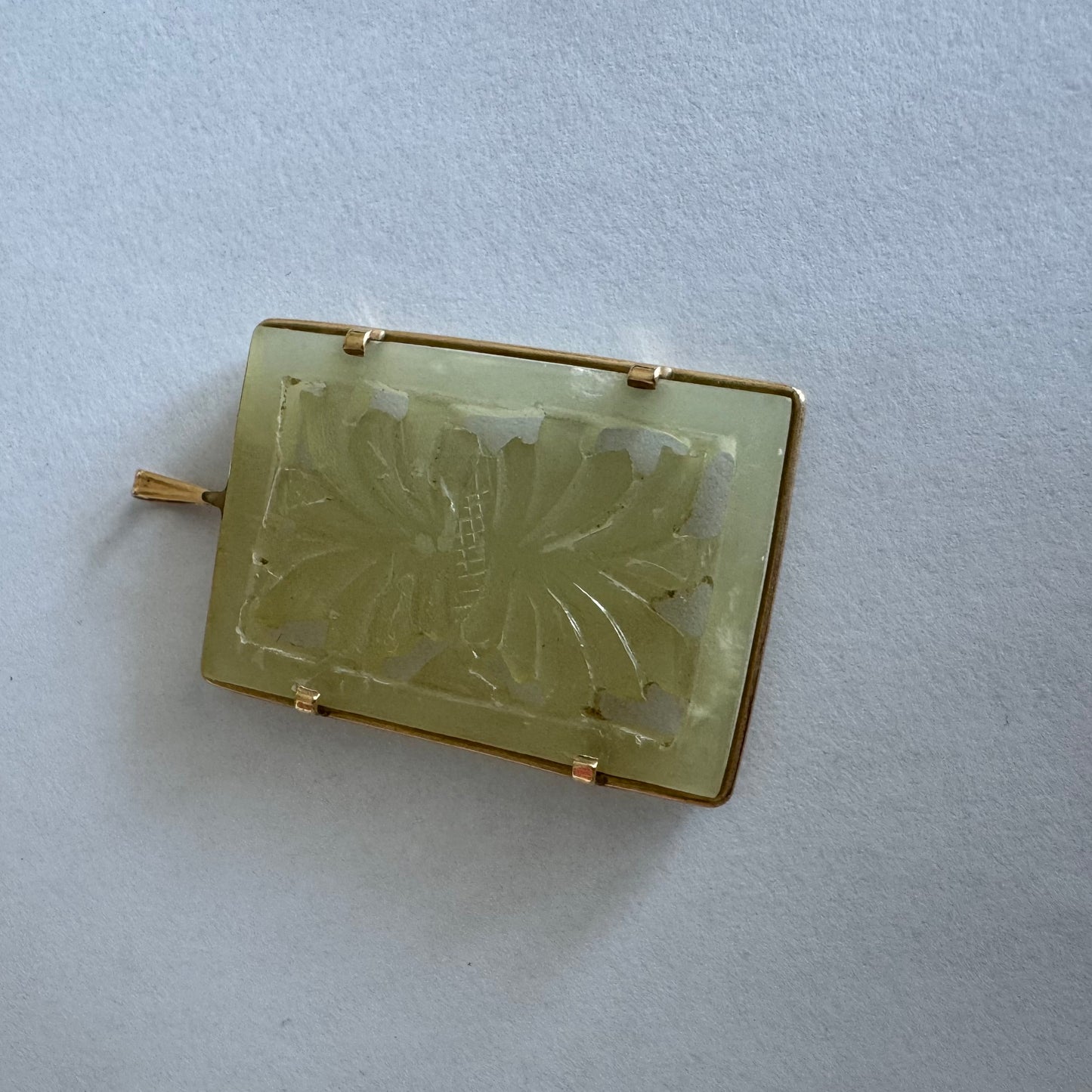 14K gold rectangular pendant set with a hand-carved milky Jade stone