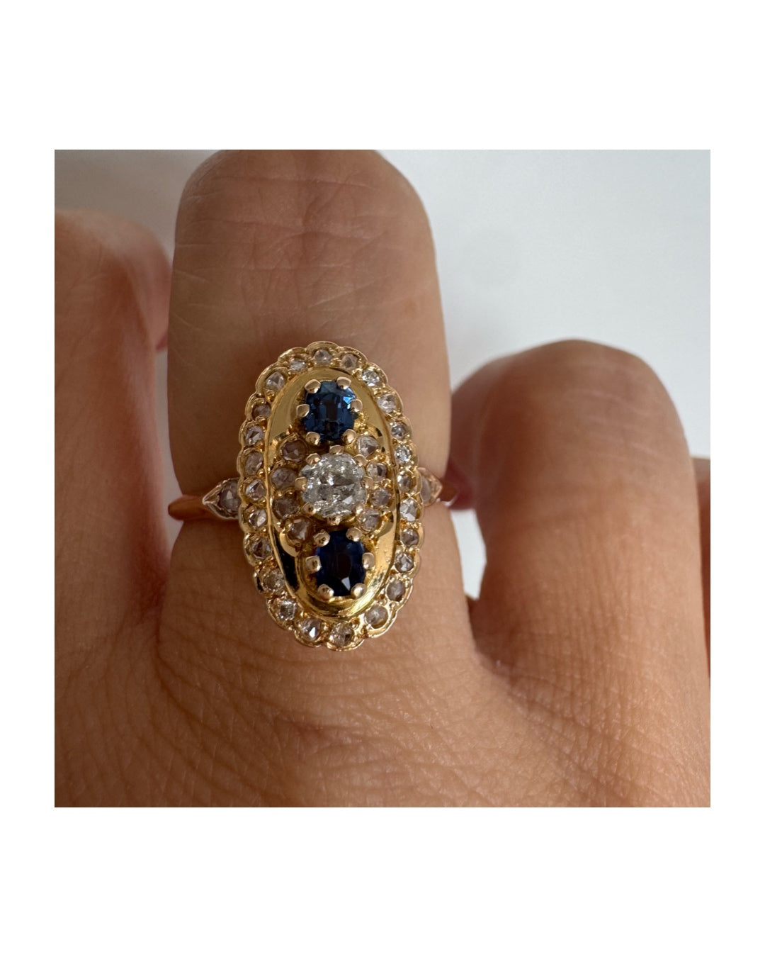 14K gold ring set with Diamonds and deep blue Sapphires in a classic oval design.