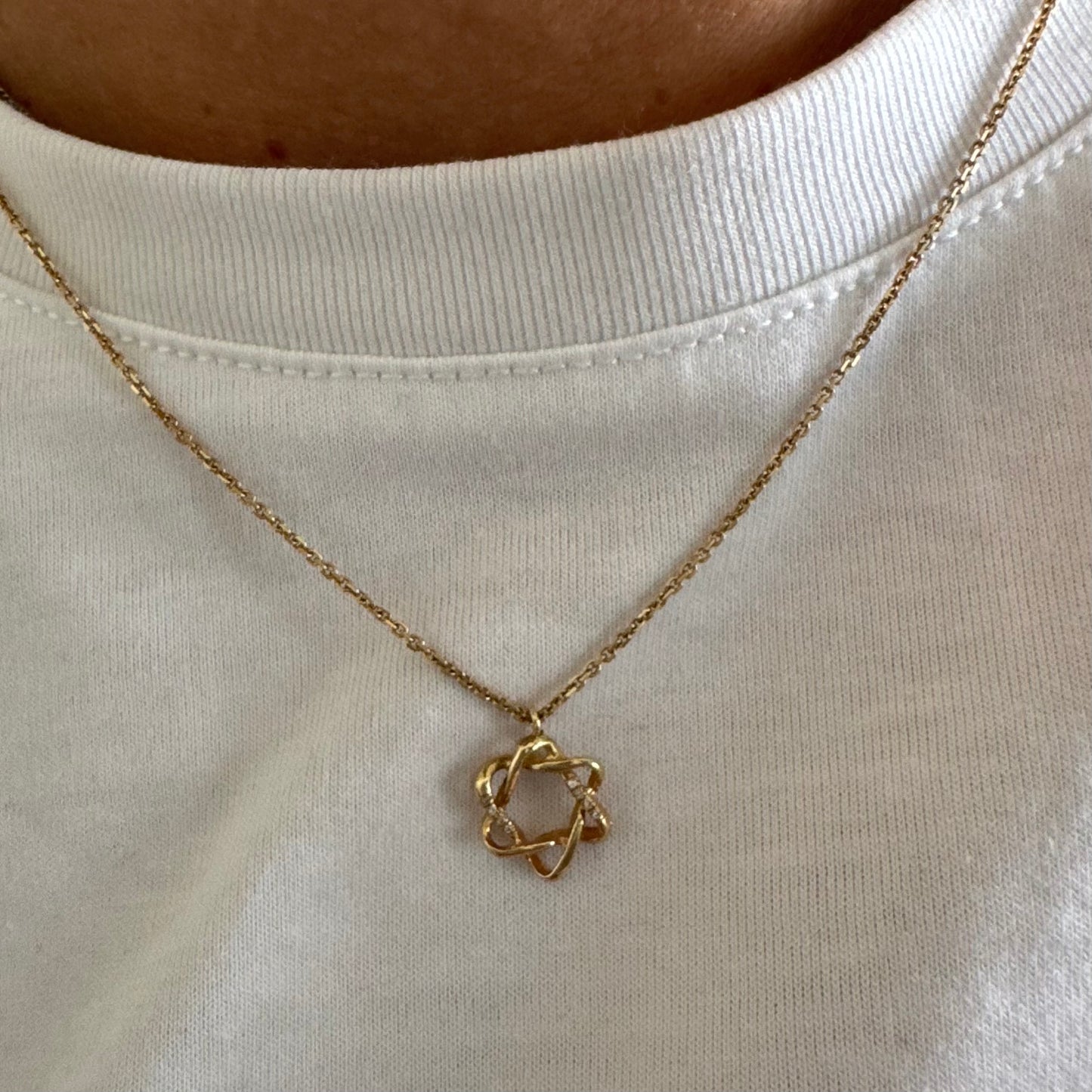 14K gold “Star of David” pendant with a sculptural open design.
