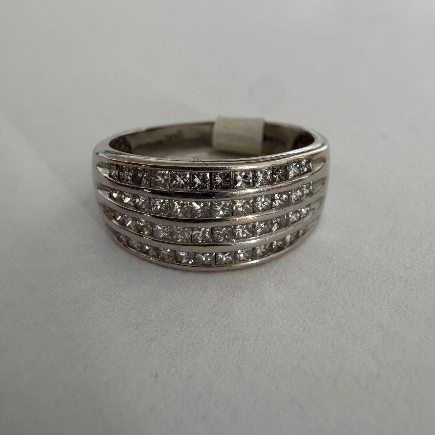 14K gold ring set with four parallel rows of princess-cut Diamonds.