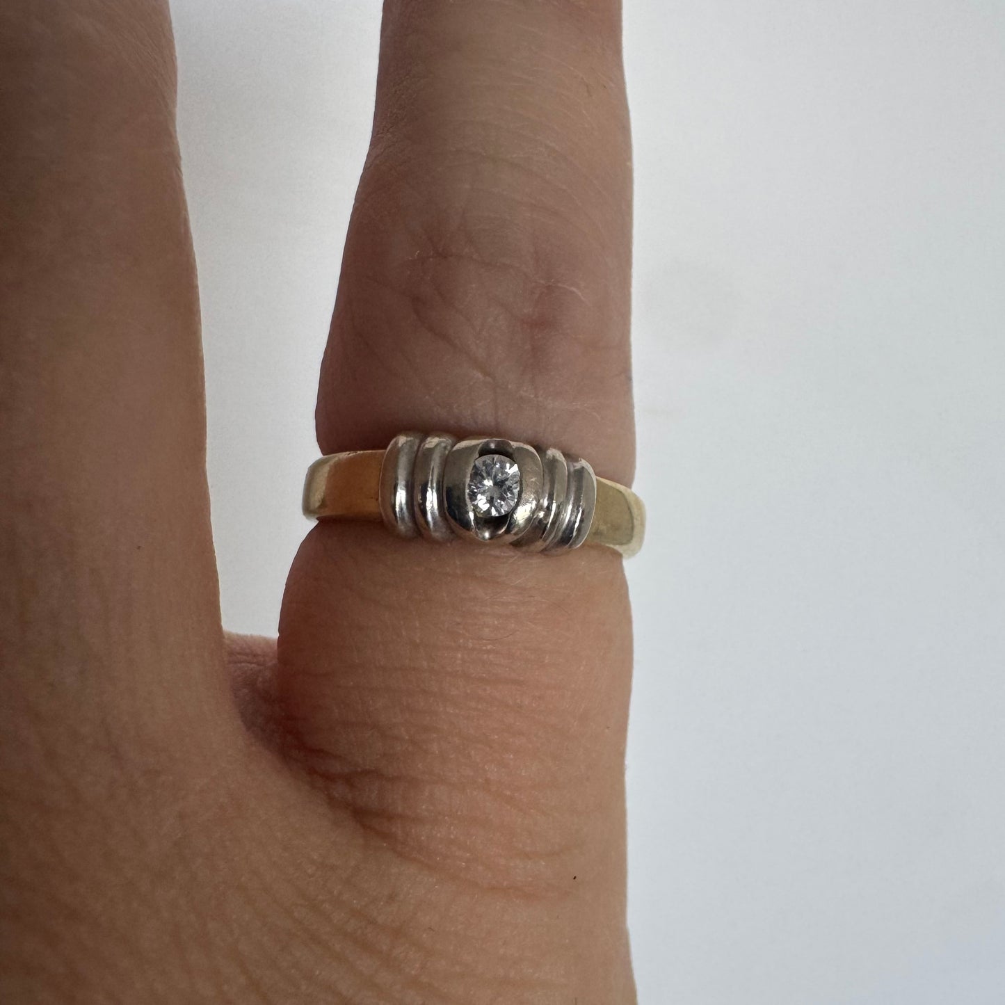 14K two-tone gold ring set with a central Diamond in a clean and refined design