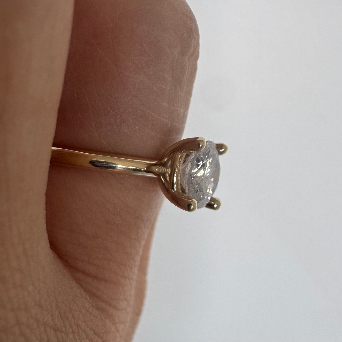 14K gold solitaire ring set with a central round Diamond