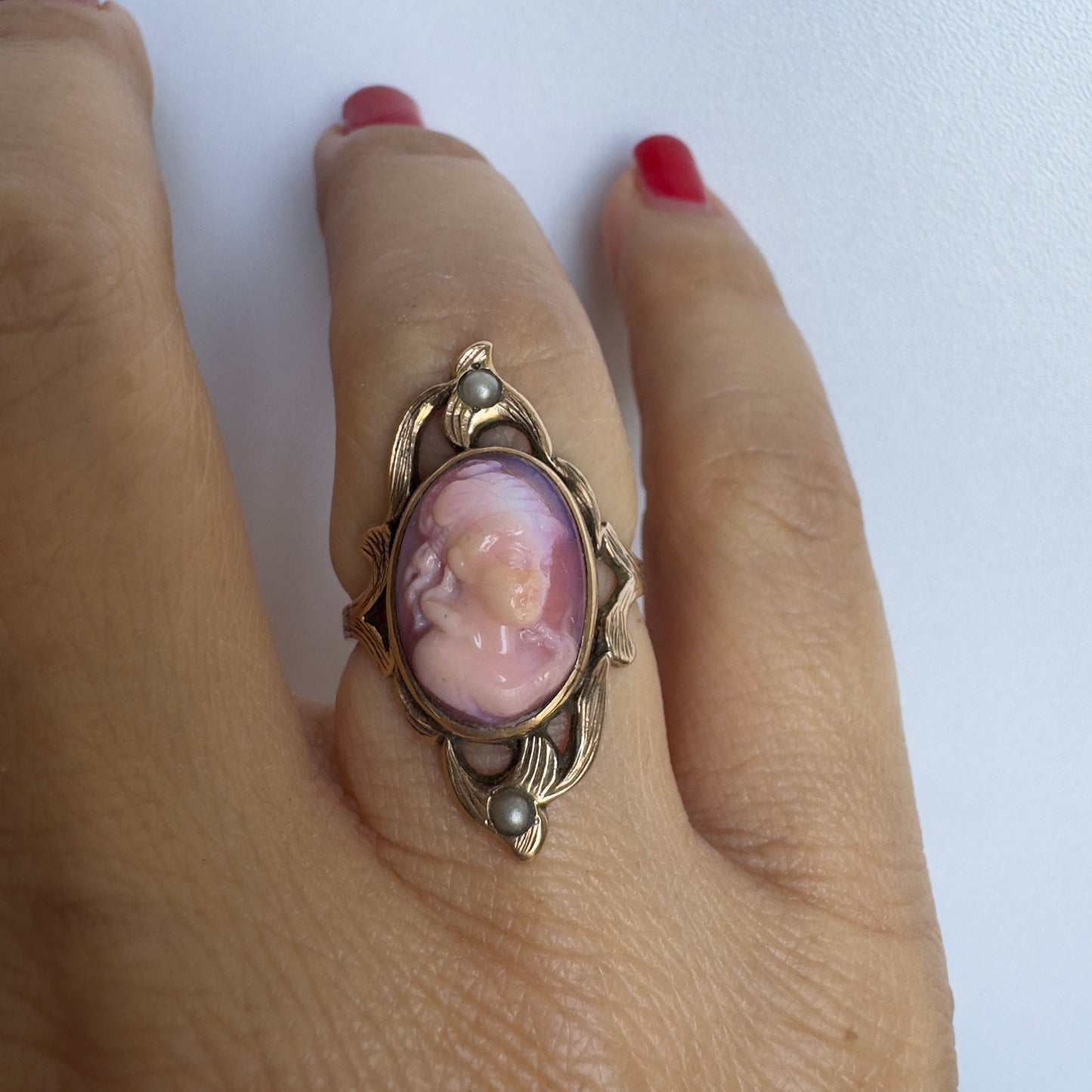 14K gold ring set with a hand-carved pink Cameo, framed by delicate details and accented with small Pearls.