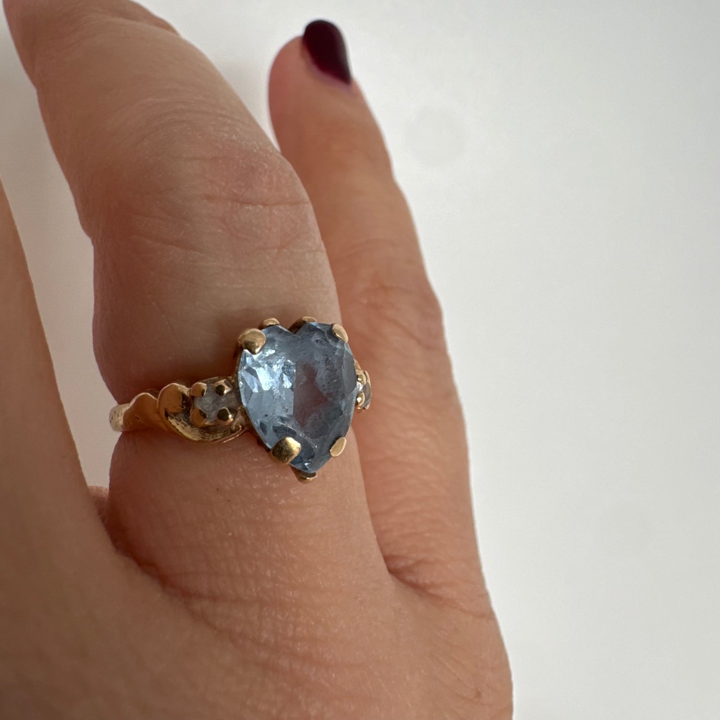 14K gold ring set with a heart-cut Blue Topaz stone