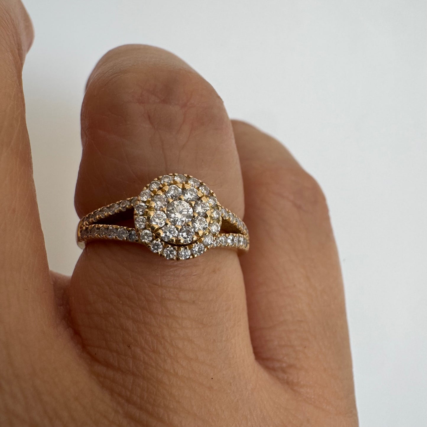 14K gold ring set with Diamonds in a sparkling halo design.