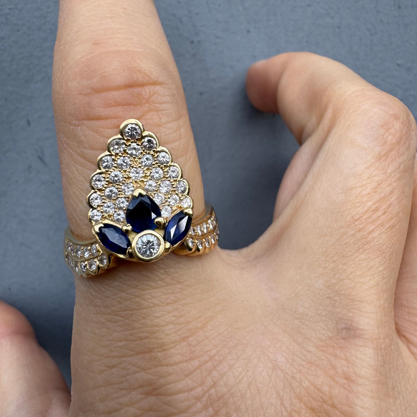 18K gold ring set with Diamonds and deep blue Sapphires, designed to make a true statement.