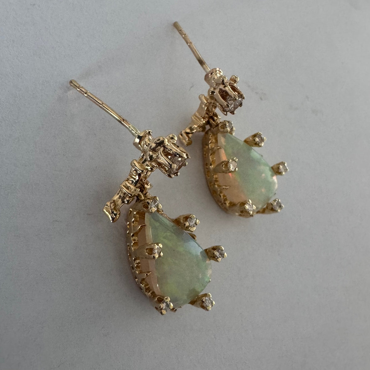 14K gold drop earrings set with pear-shaped Opals and Diamonds.