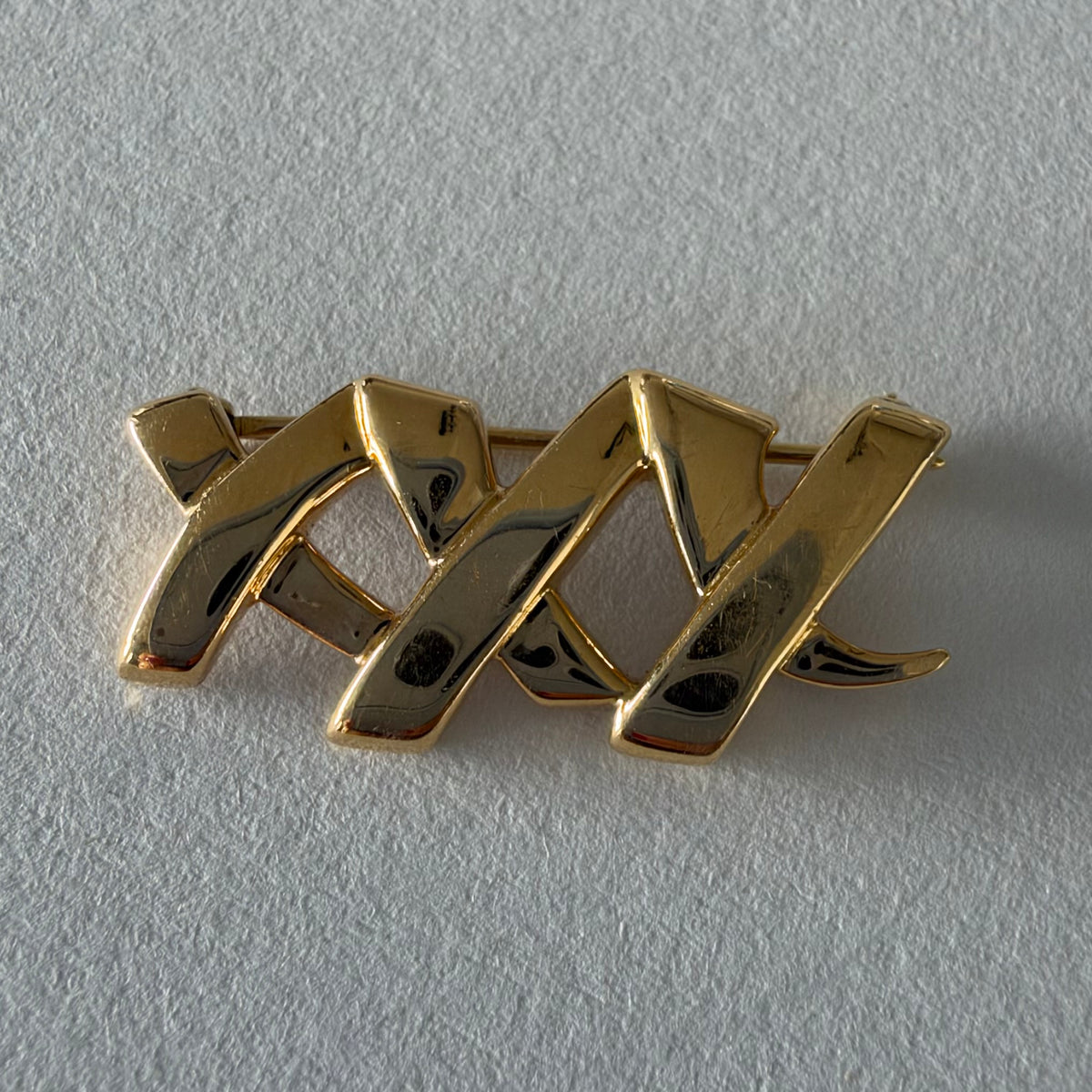 A Tiffany & Co. 18K gold brooch designed by Paloma Picasso from the iconic Graffiti Collection.