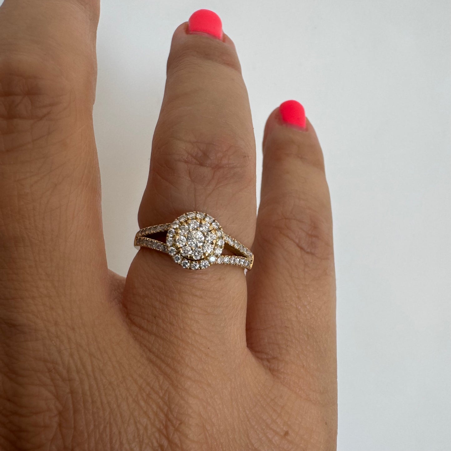 14K gold ring set with Diamonds in a sparkling halo design.