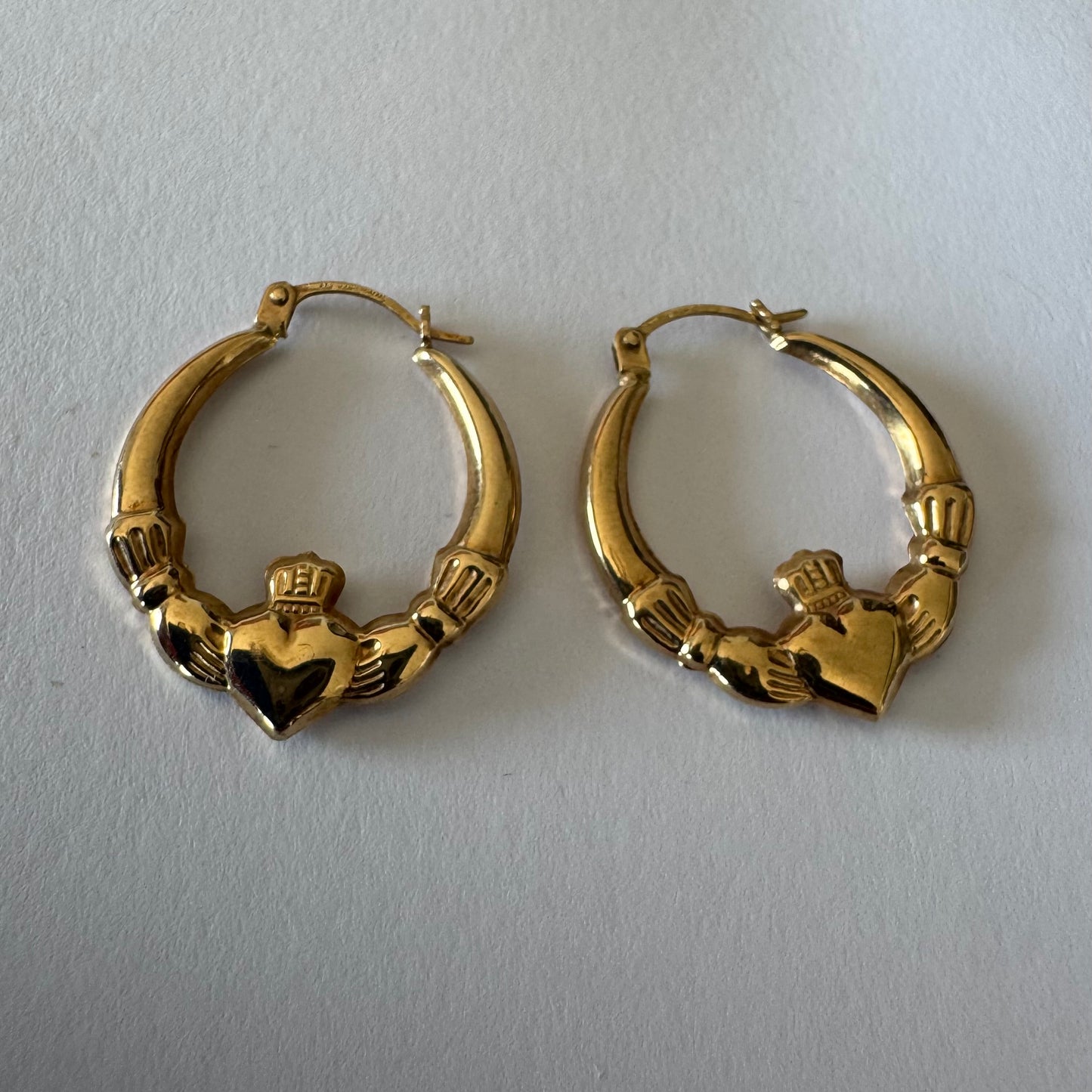 9K gold Claddagh earrings, featuring the iconic Irish motif of a heart held by two hands and topped with a crown, traditionally symbolizing love, friendship and loyalty.
