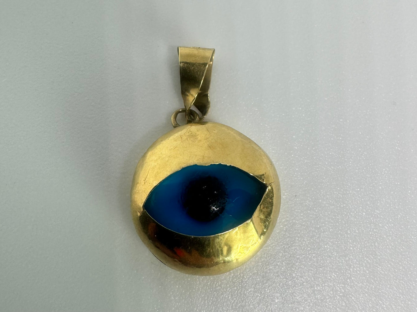 14K gold pendant set with “evil eye”