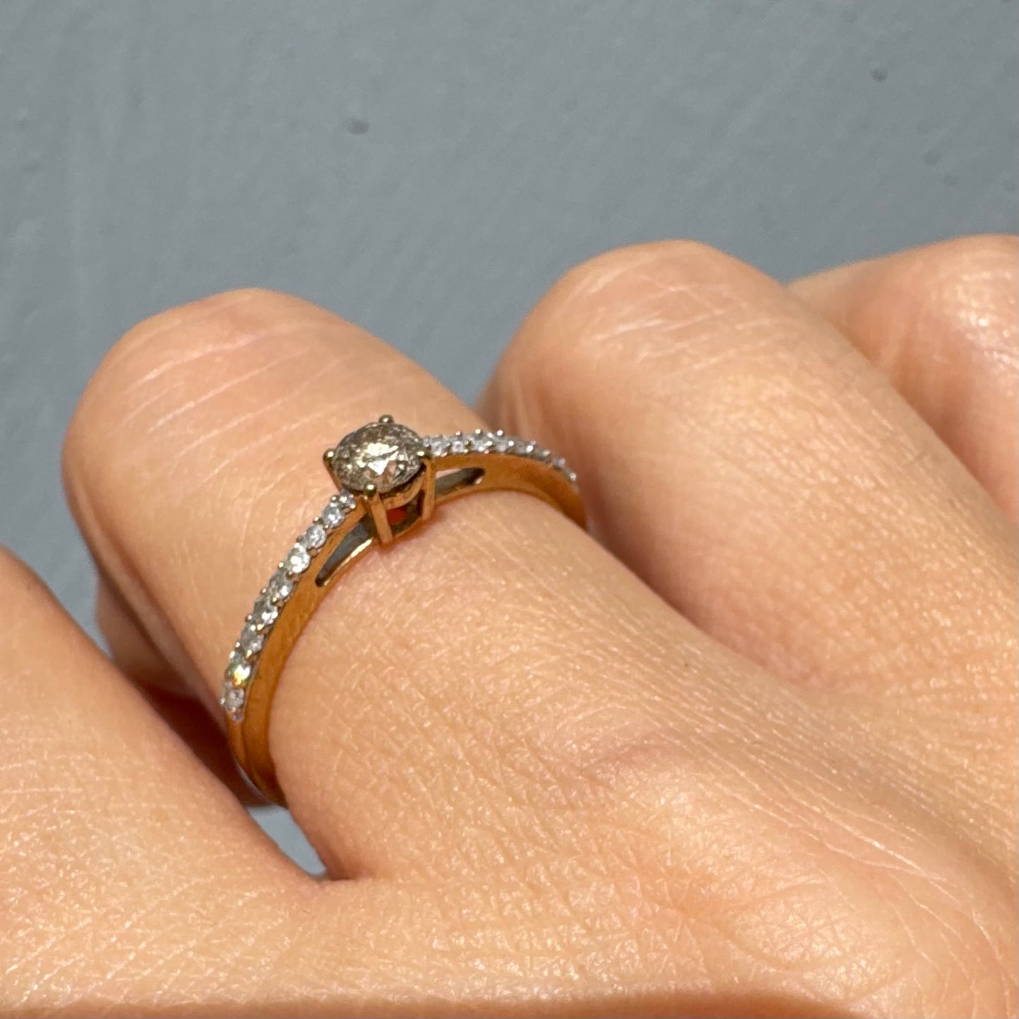 9K gold ring set with a central Diamond and sparkling Diamonds along the band