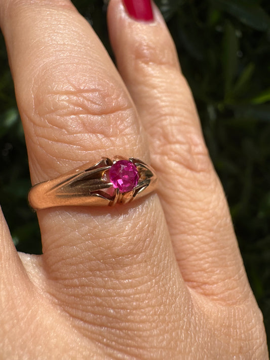 14K gold ring set with a vivid pink round-cut Ruby